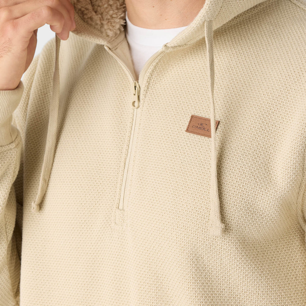 
                      
                        A man wearing the Light Khaki Passage Fleece Quarter Zip Pullover Hoodie by O'Neill with the hood up
                      
                    