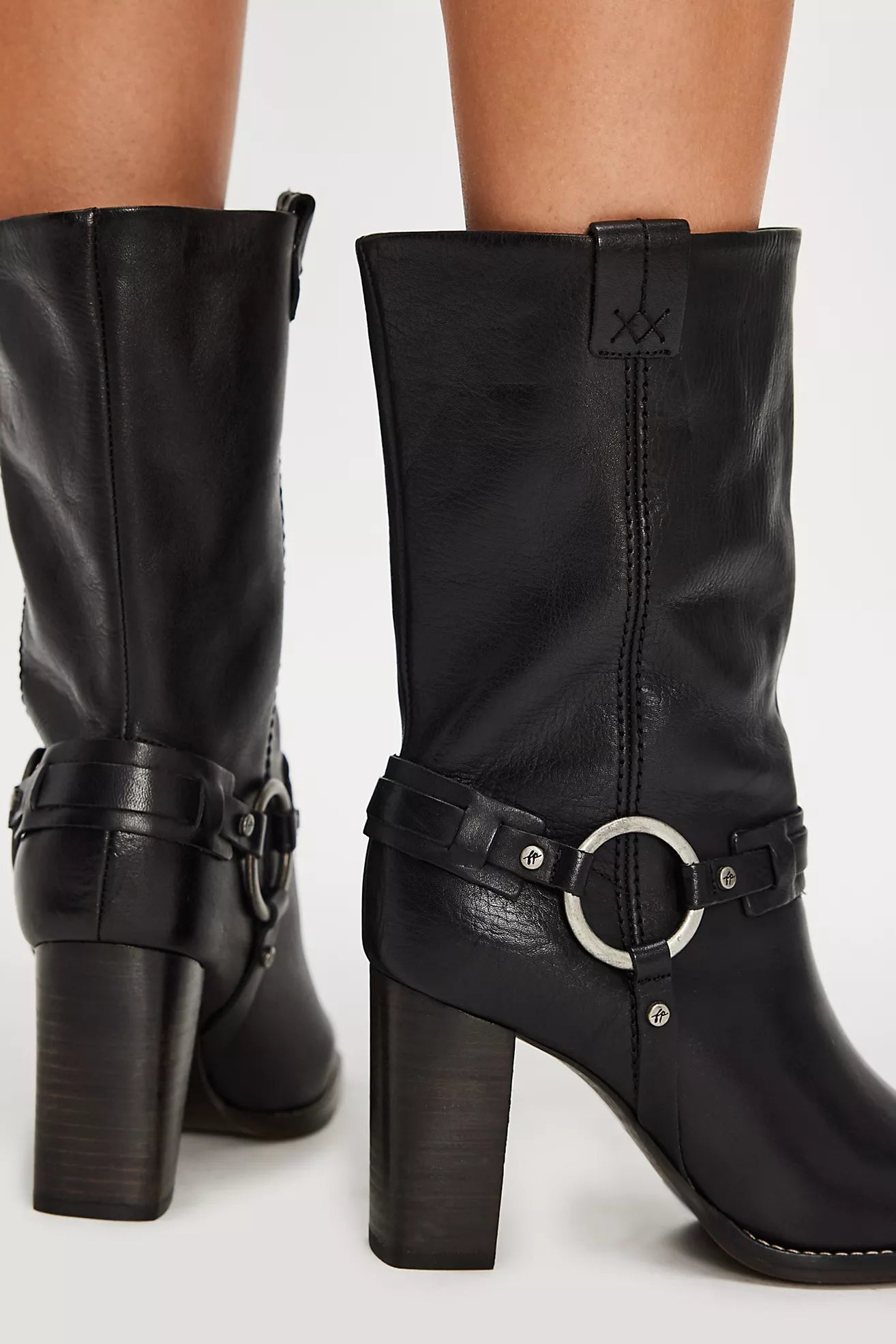 Add some edge to any outfit with these mid-calf black leather boots from Free People, now at Harbour Thread boutique.