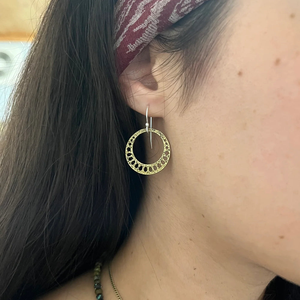 A woman wearing the Tiny Brass Lotus Root Earrings from Jennifer Kahn Jewelry