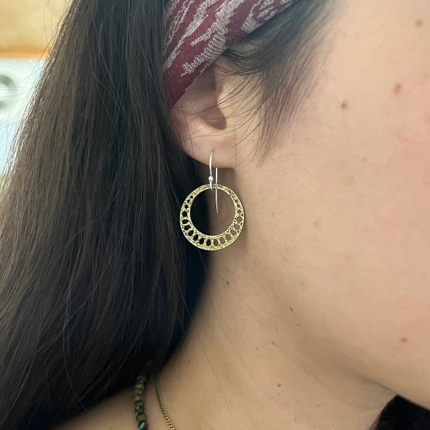 A woman wearing the Tiny Brass Lotus Root Earrings from Jennifer Kahn Jewelry