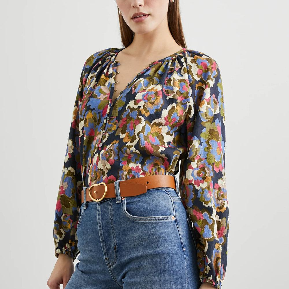 
                      
                        A woman wearing the Navy Wildflower print Indi Long Sleeve Top by the brand Rails
                      
                    