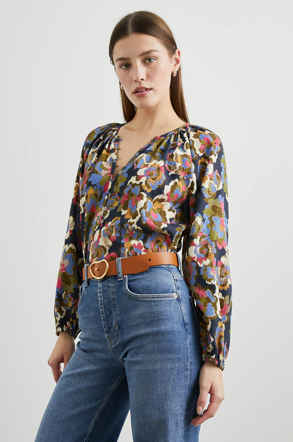 A woman wearing the Navy Wildflower print Indi Long Sleeve Top by the brand Rails