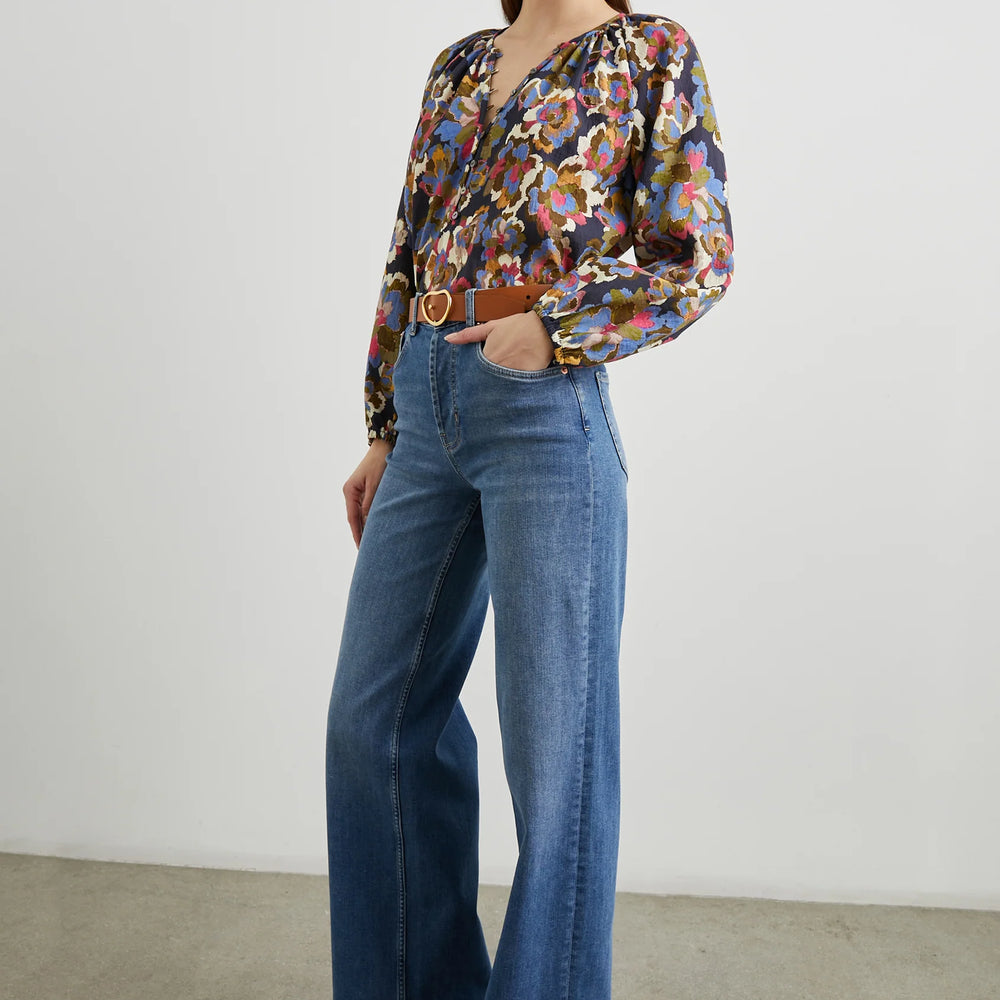 
                      
                        A woman wearing an outfit styled with the Navy Wildflower print Indi Long Sleeve Top by the brand Rails
                      
                    