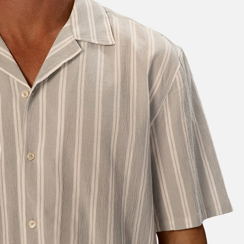 The New Striped Magna Short Sleeve Shirt by Industrie offers a breathable and textured fabric for warm summer days. 