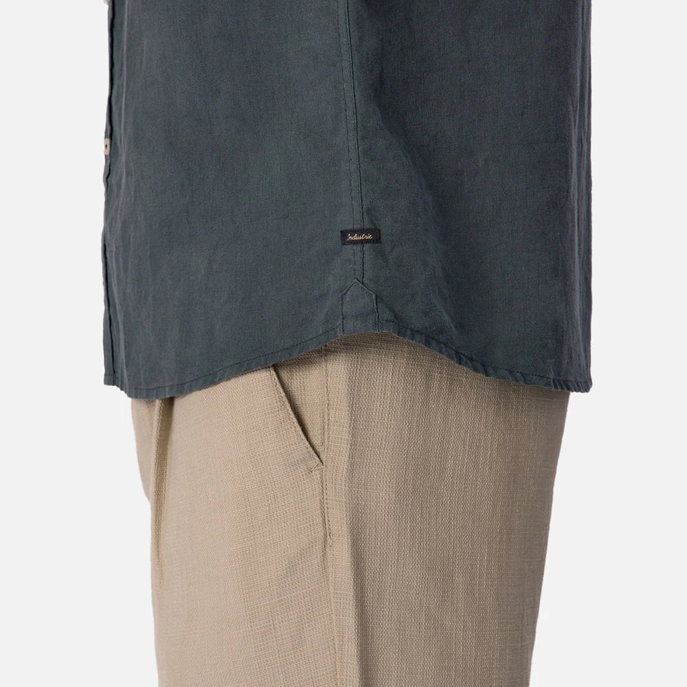 
                      
                        Dark blue shirt over beige pants on a white background
                      
                    