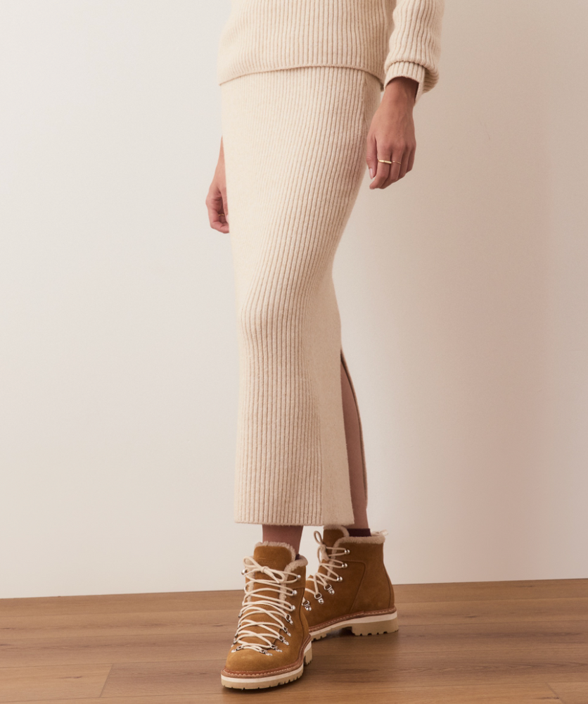 
                      
                        The Isla Sweater Skirt features a ribbed knit design and back slit detail for easier movement. 
                      
                    