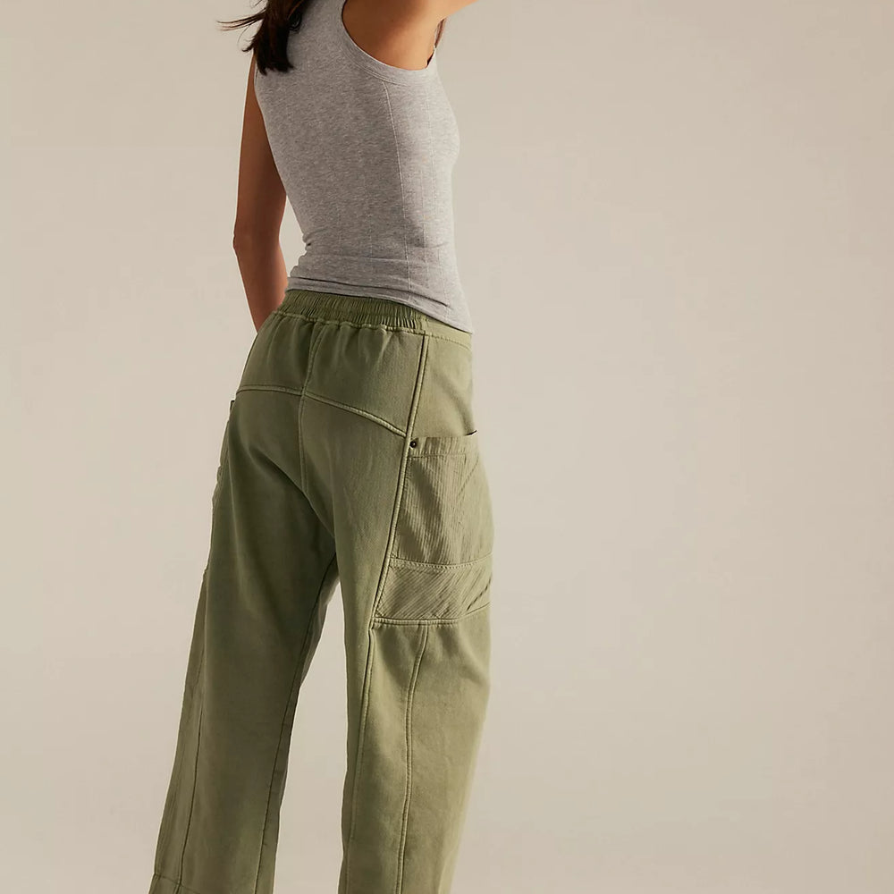
                      
                        A woman wearing green utility-inspired pants by Free People. 
                      
                    