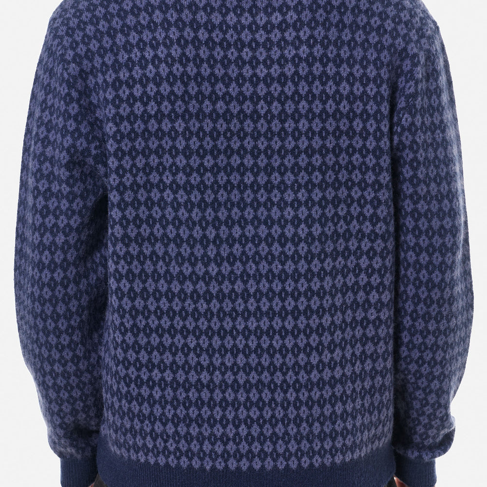 
                      
                        Man wearing a blue argyle patterned sweater
                      
                    