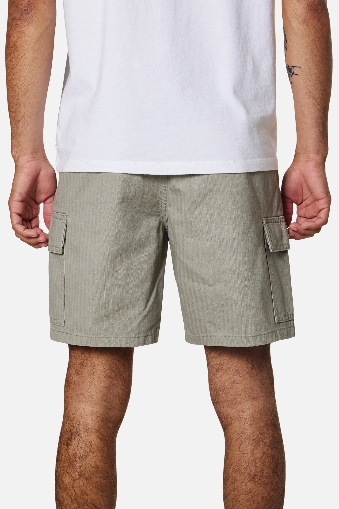 Back view of a man wearing the warm grey colored men's cargo shorts by Katin