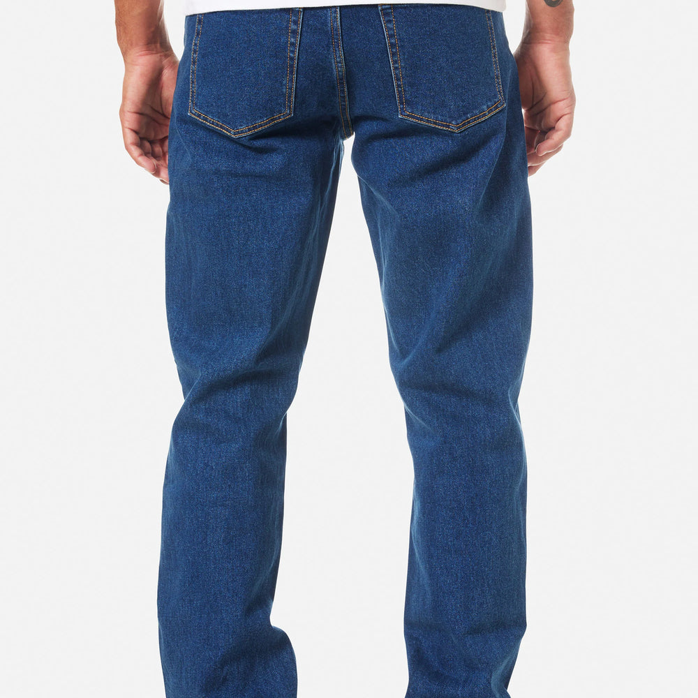 Person wearing Katin blue jeans on a white background