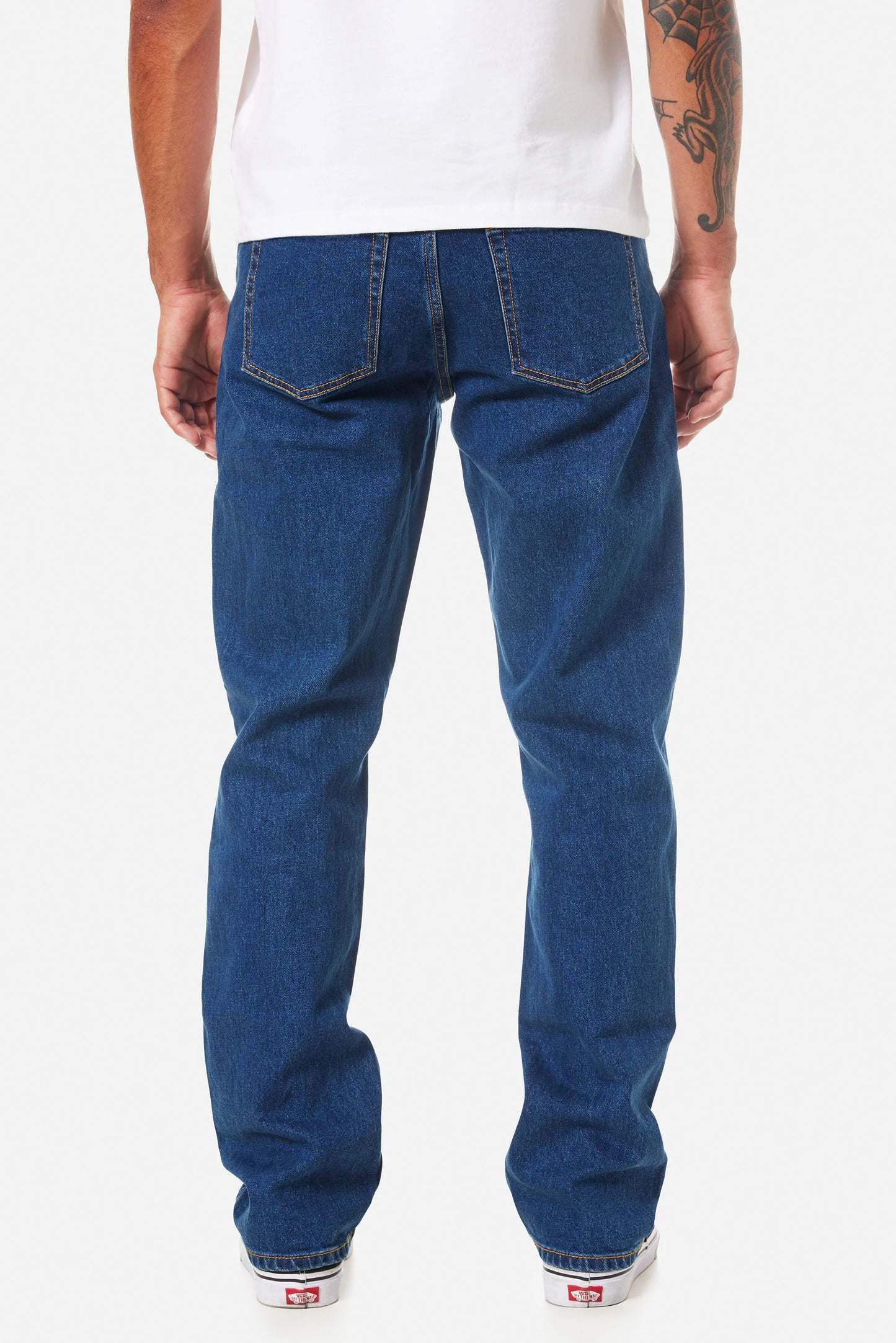 Person wearing Katin blue jeans on a white background