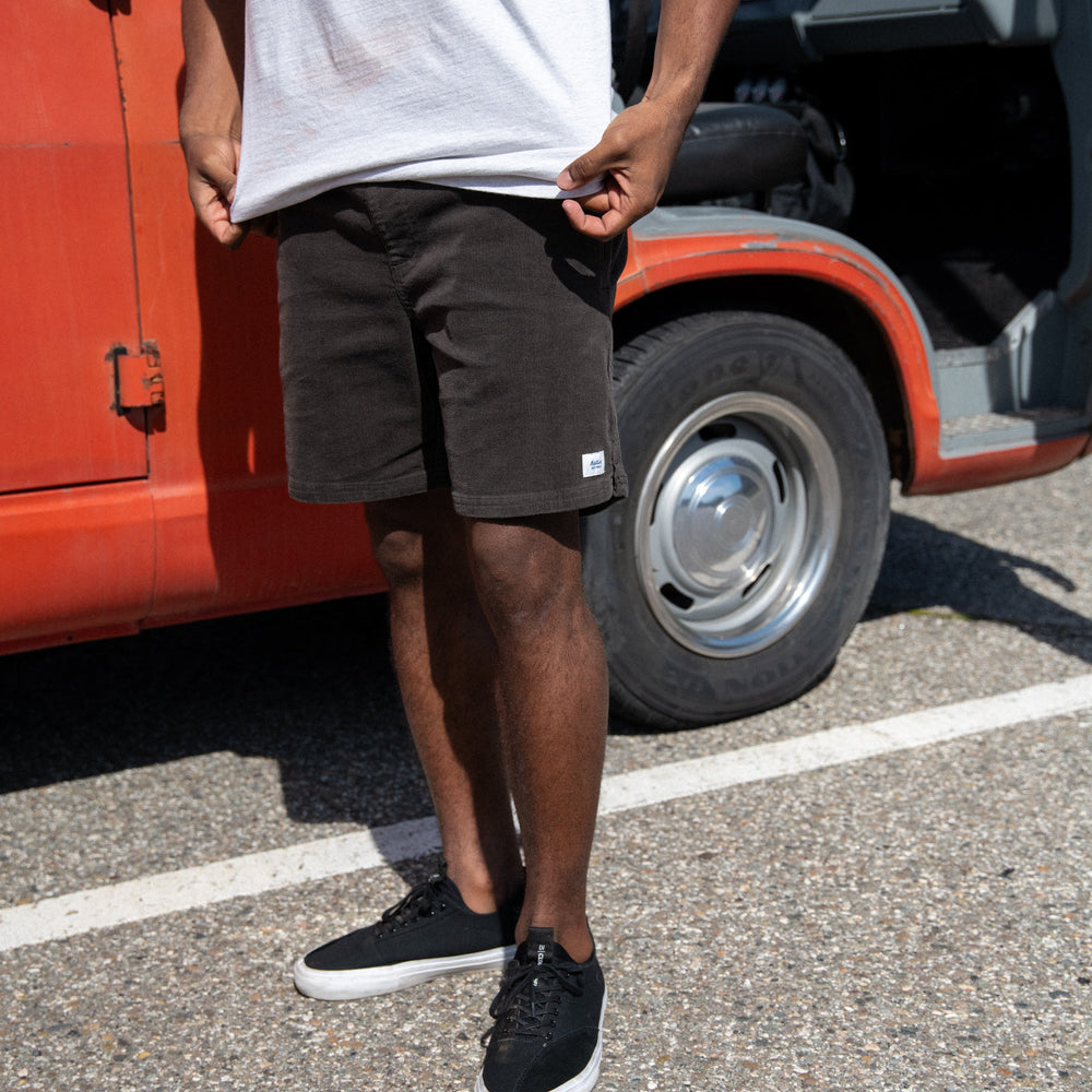Man outside wearing the Black Wash Cord Local Men's Short by Katin