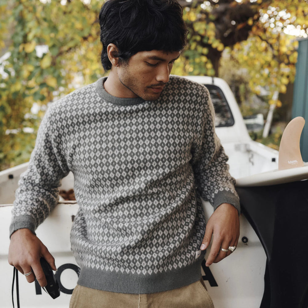 Man wearing the Gray Green Katin Check Sweater while standing next to a white truck with autumn trees in the background
