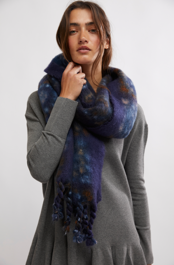 A woman wearing Free People's Kaleidoscope Blanket Scarf in the color Midnight