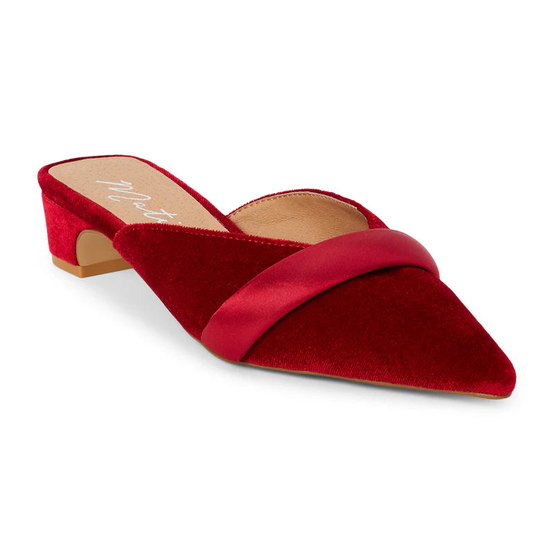 
                      
                        The Kellan Heeled Mule by Matisse offers an upper crafted from red velvet and satin 
                      
                    