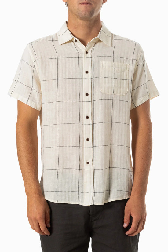 Front view of a man wearing a white short sleeve button up shirt with a thin black plaid design