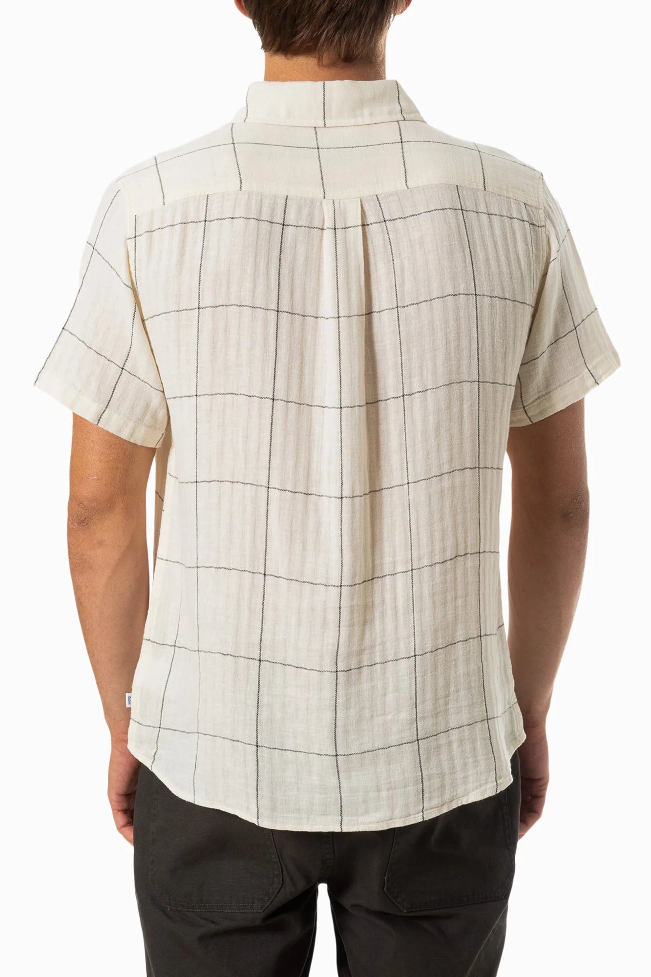 Back view of a man wearing a white short sleeve button up shirt with a thin black plaid design