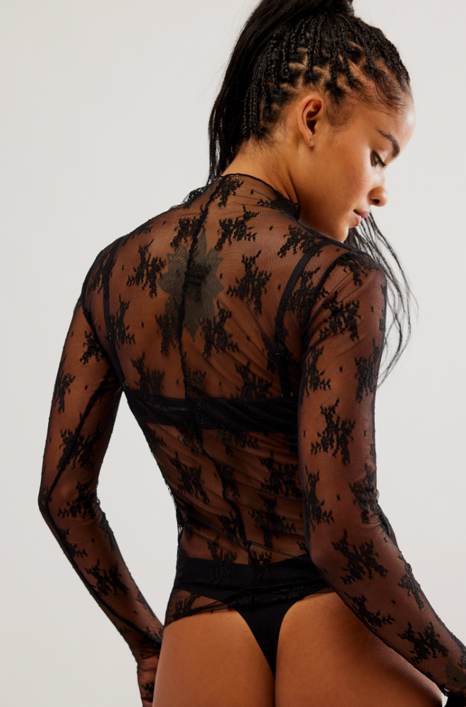 
                      
                        Back view of a woman wearing the Lady Lux Black Layering Top by Free People
                      
                    