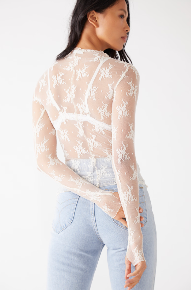 Back view of a woman wearing the Lady Lux Evening Creme Layering Top by Free People