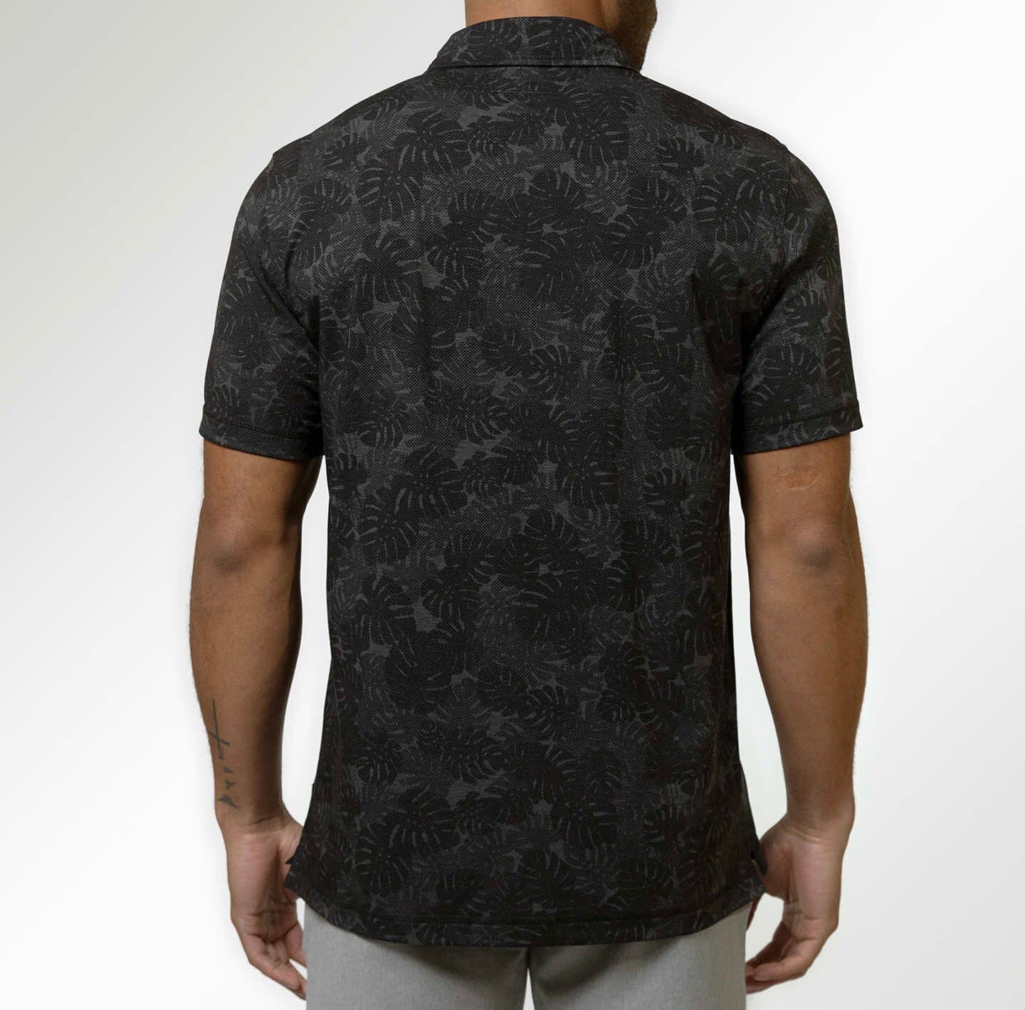 Back view of the Black Heather Monstera Printed Delray Polo by LINKSOUL