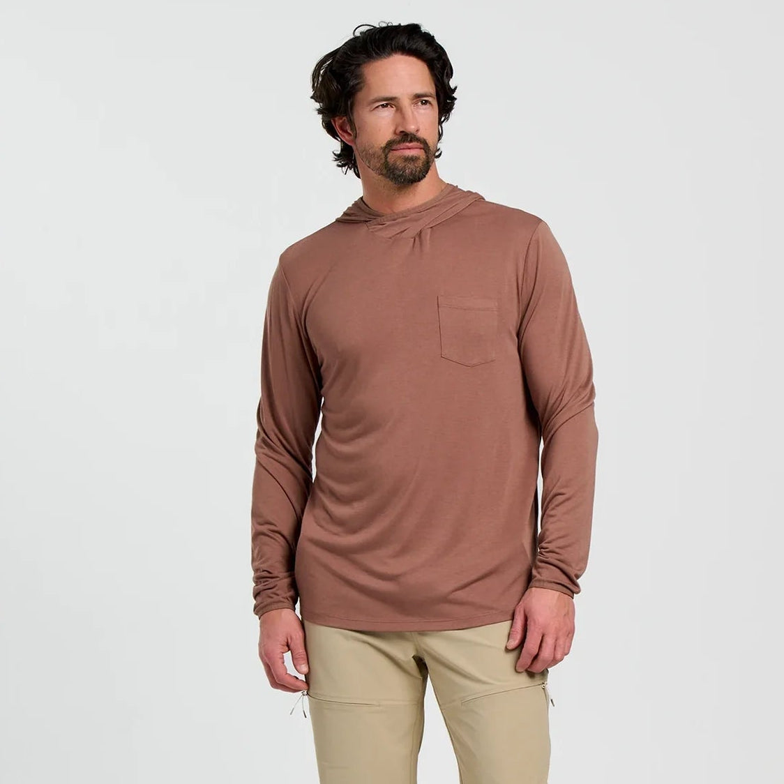 A man wearing the Men's Bamboo Lightweight Hoodie by Free Fly in the color Nutmeg