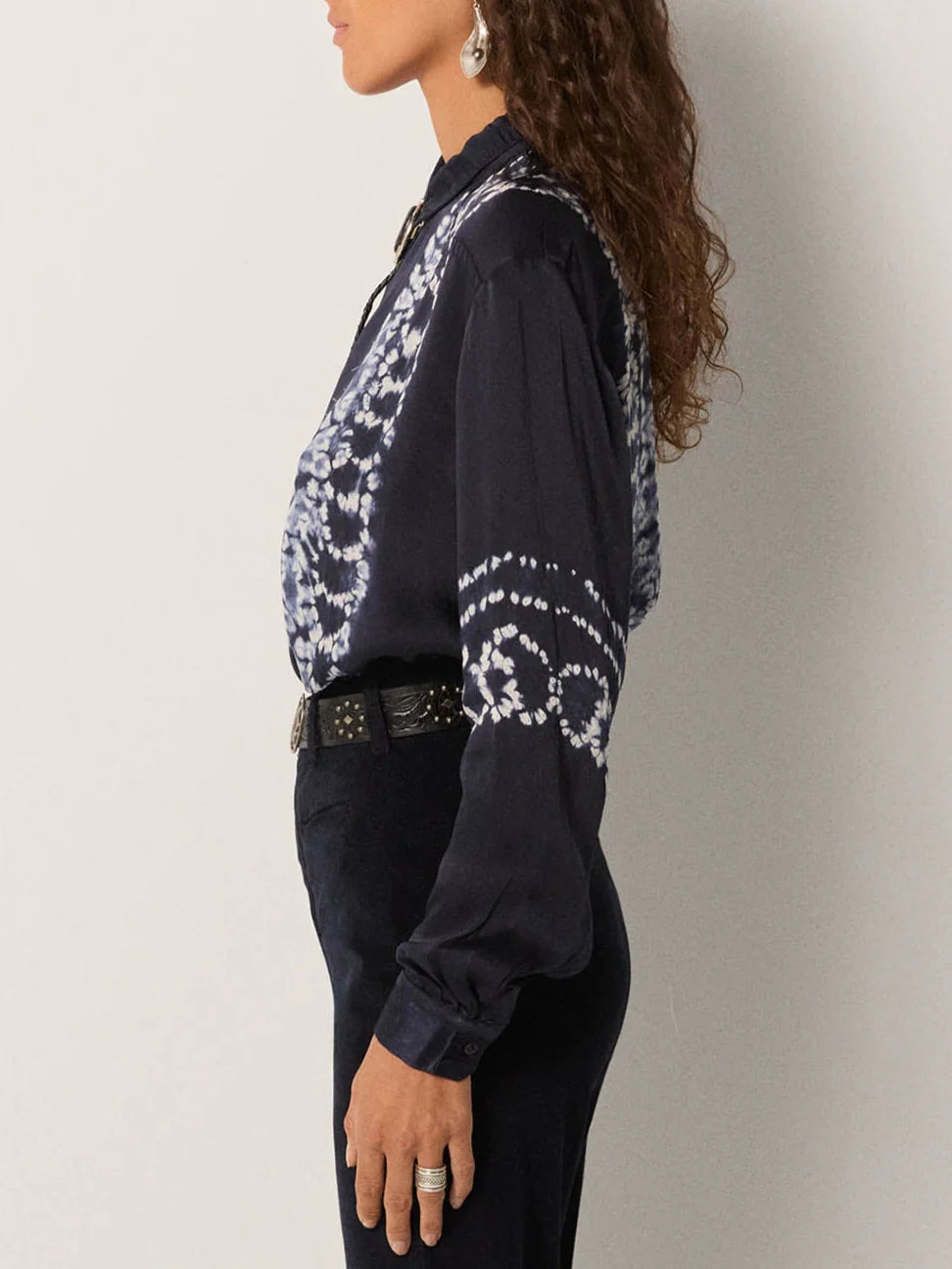 Person wearing a dark blue patterned shirt 