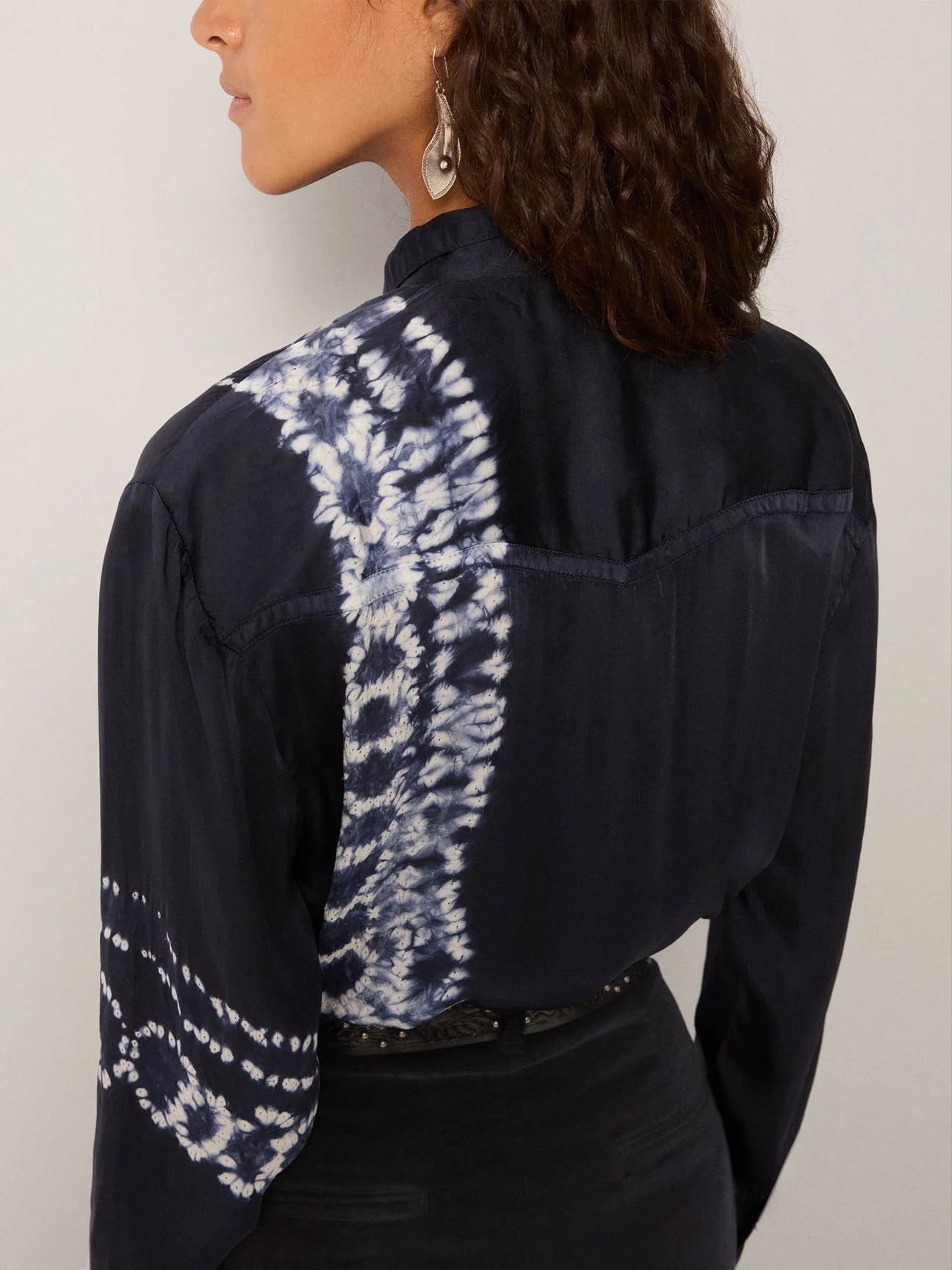 Navy blue shirt with white patterned shoulder detail on a plain background