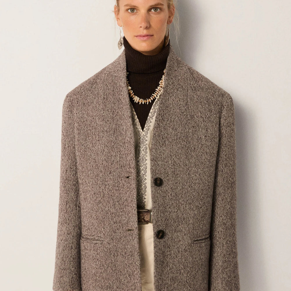 Person wearing a brown textured blazer coat