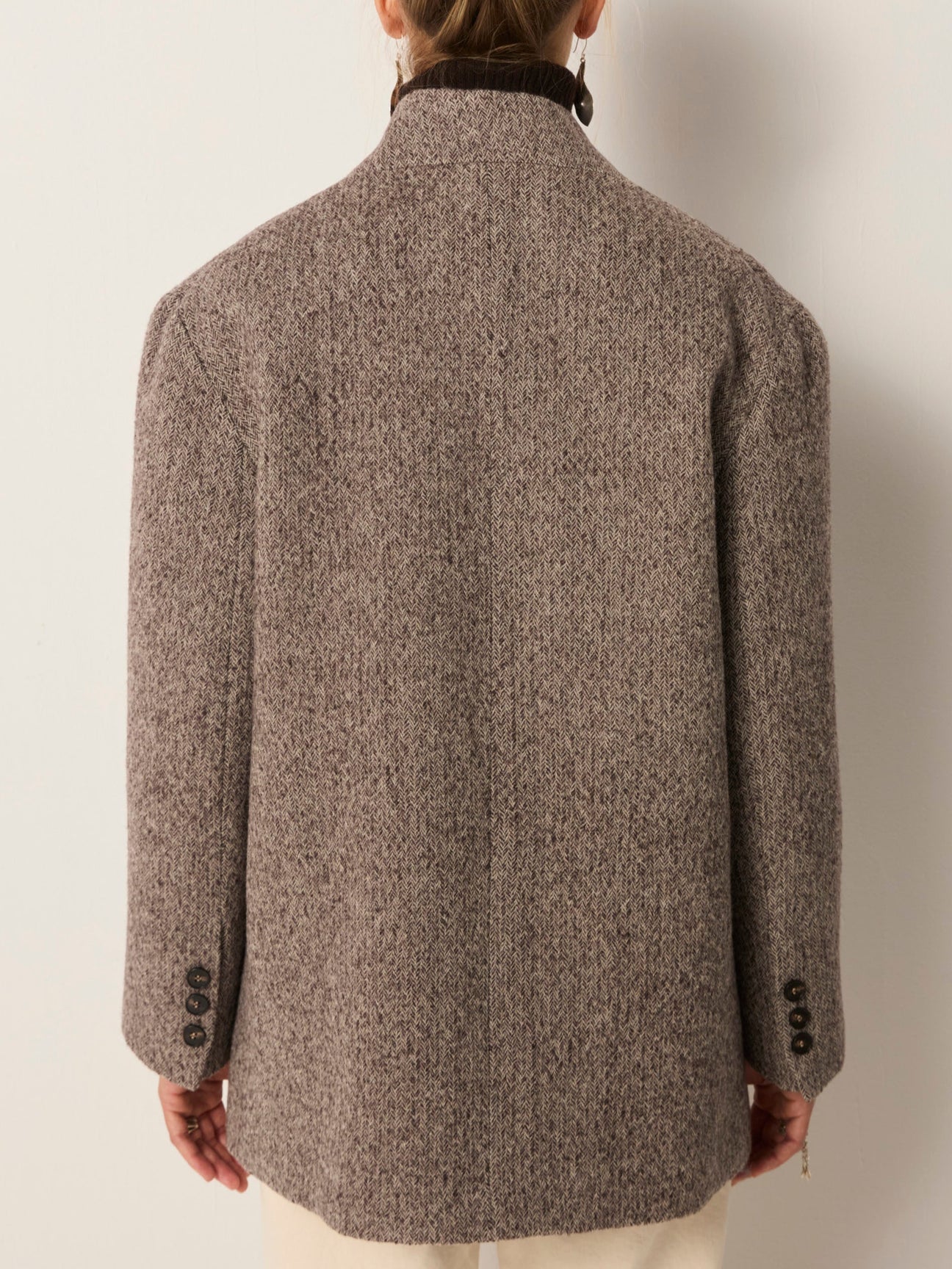 Back view of a person wearing a wool blazer jacket