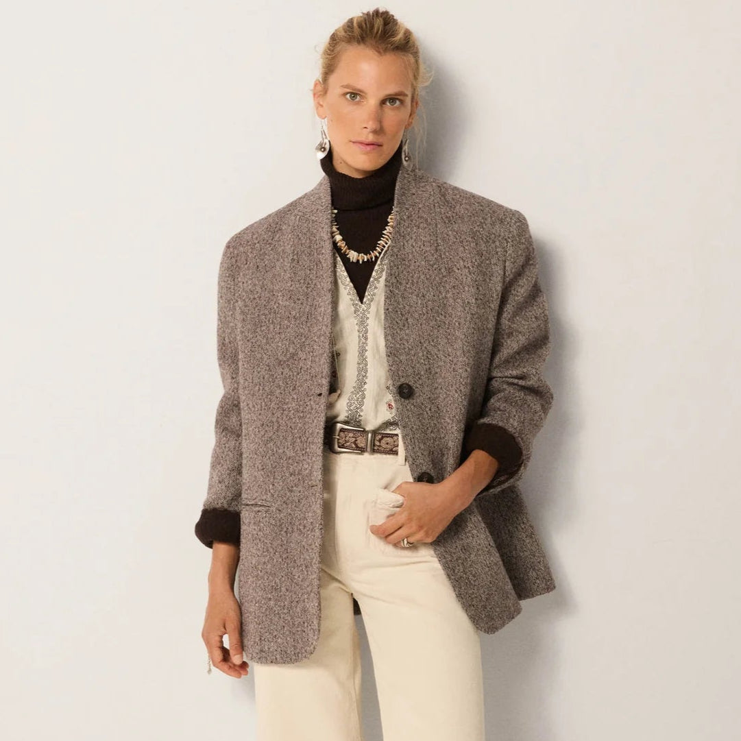 A woman wearing the Maison Hotel Clementine Jacket in the color Ash Mist