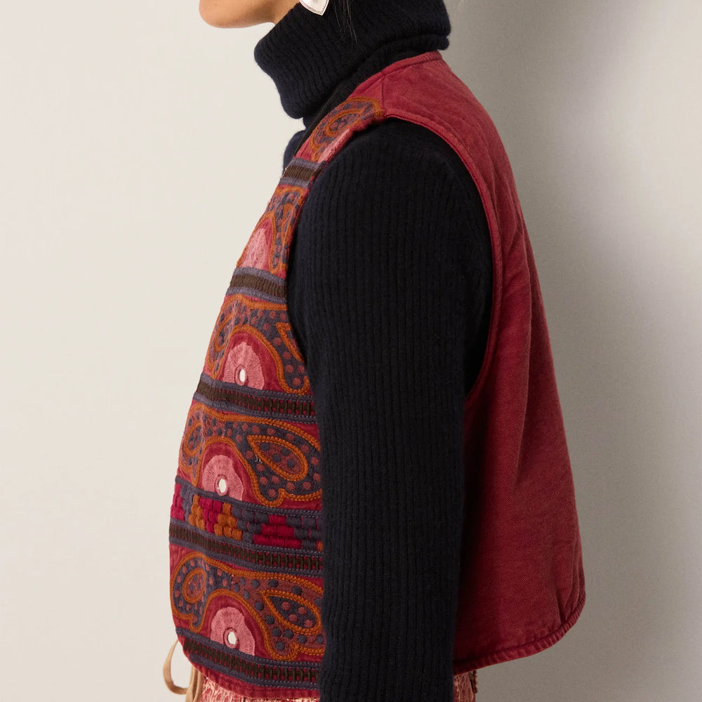 
                      
                        A woman wearing the Gypsy Sun Burgundy Elodie Vest by Maison Hotel over a black turtleneck
                      
                    