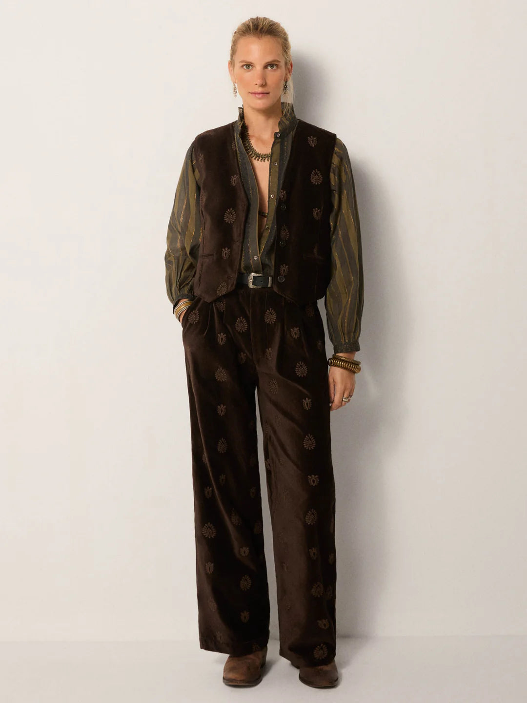 A woman wearing the Velluto Macchiato Kafka Vest by Maison Hotel paired with matching trousers 