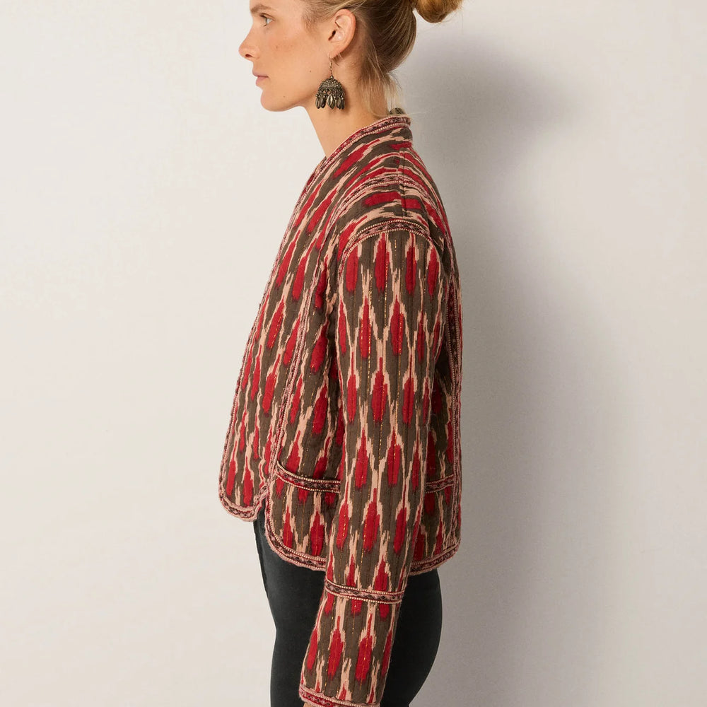 
                      
                        Woman wearing a patterned jacket with long sleeves from Maison Hotel
                      
                    