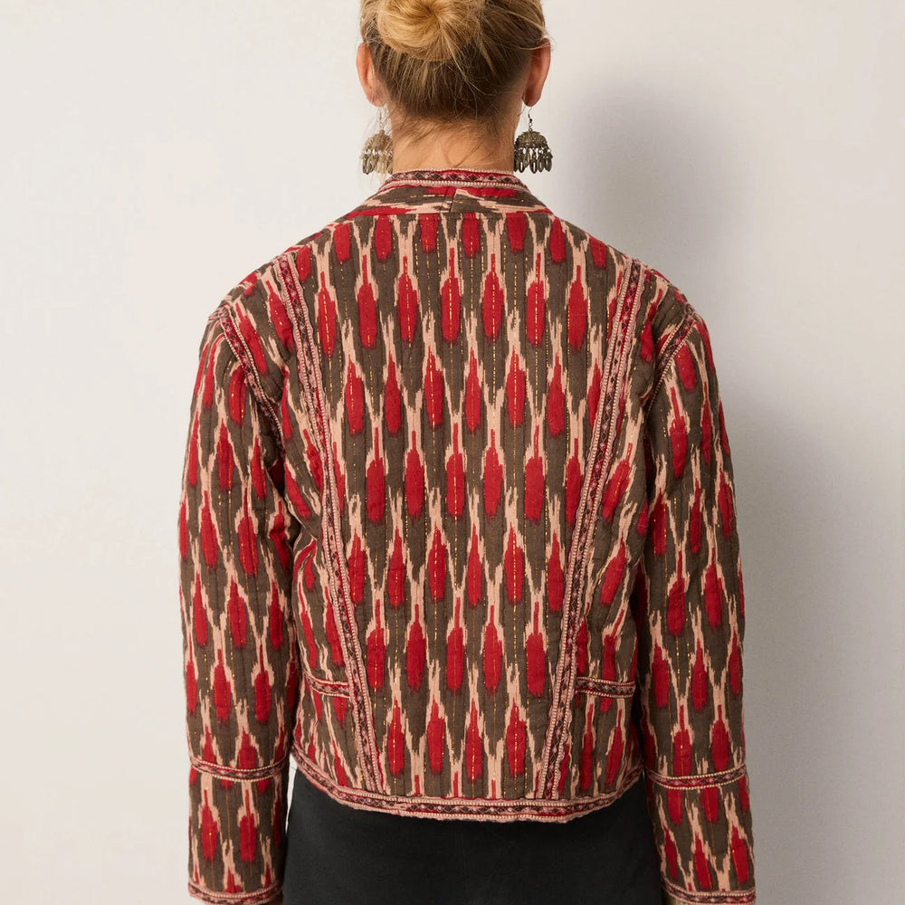 Person wearing a patterned jacket from Maison Hotel