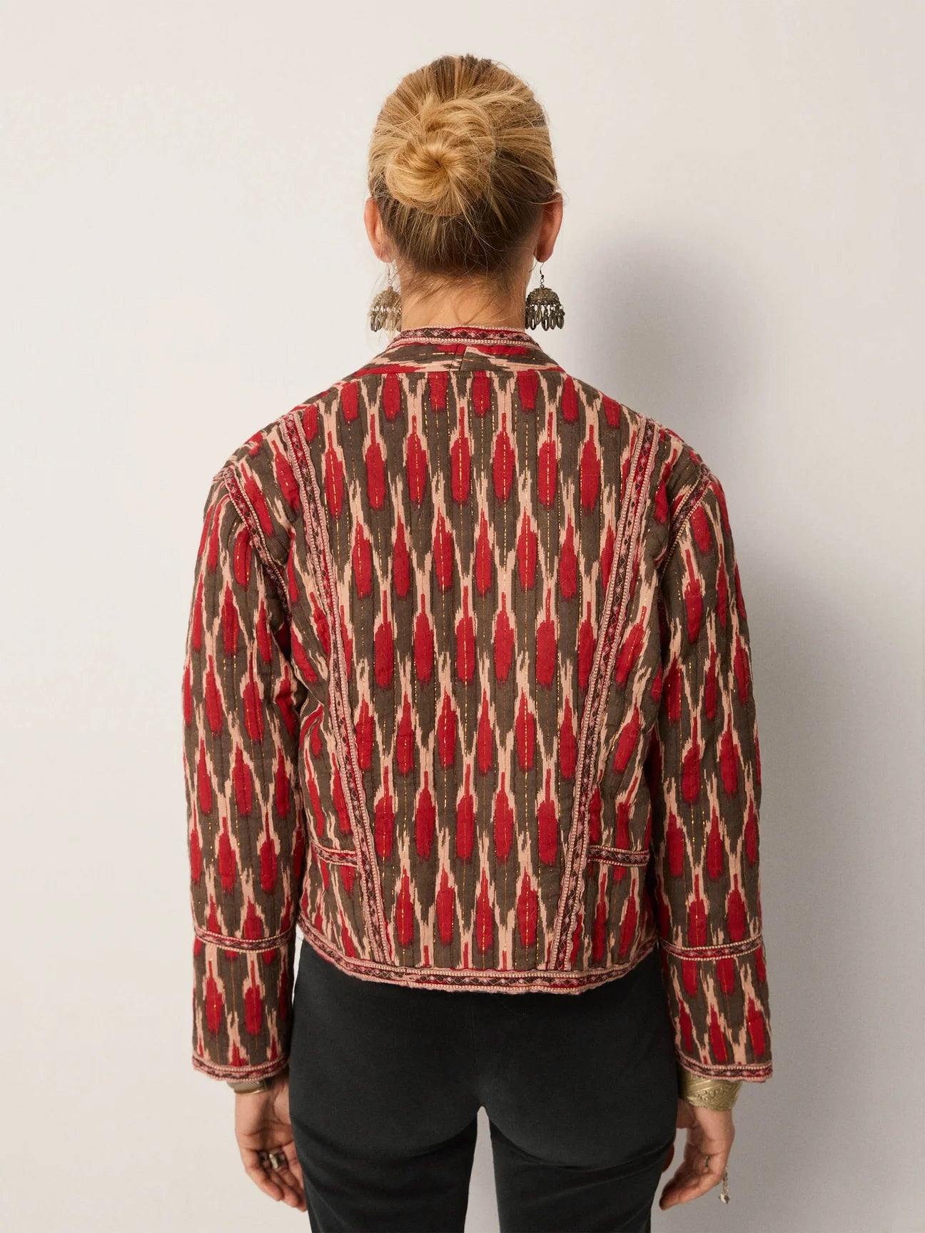 Person wearing a patterned jacket from Maison Hotel