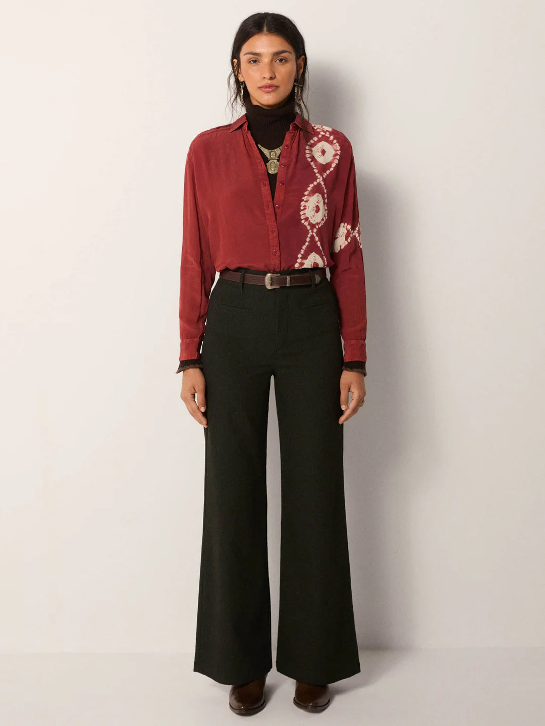 Woman wearing a red patterned button down blouse tucked into the Ash Heritage Carlo Pant by Maison Hotel