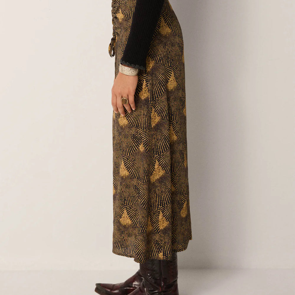 
                      
                        The Maison Hotel Lala Skirt paired with boots and a black top
                      
                    
