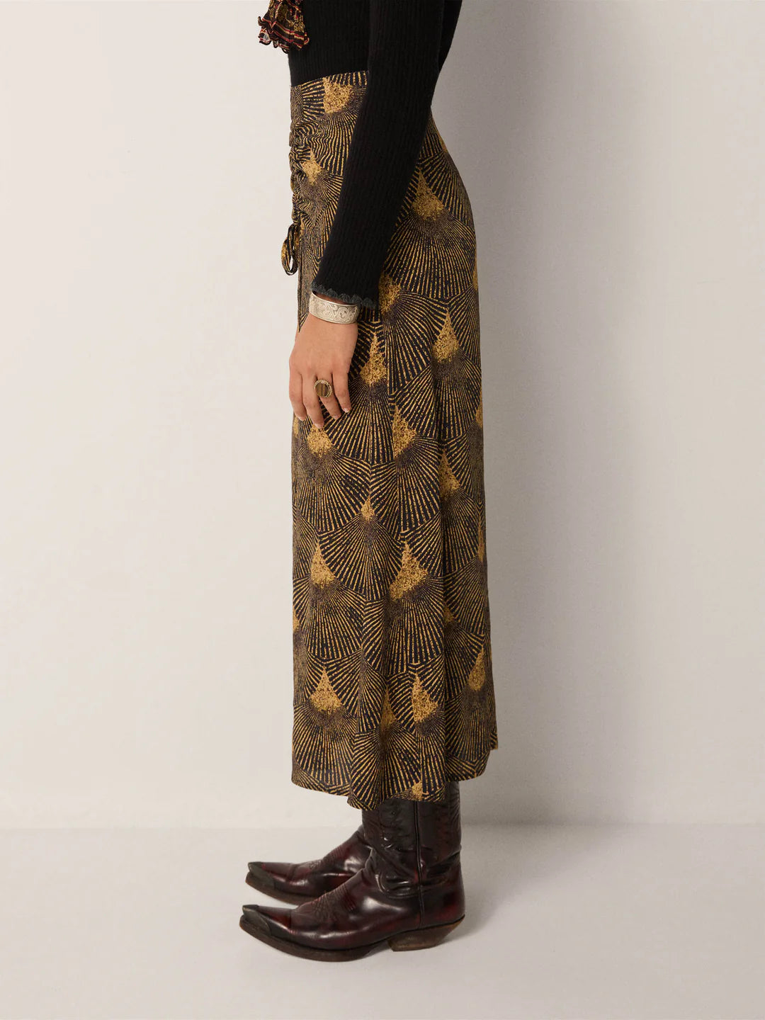 The Maison Hotel Lala Skirt paired with boots and a black top
