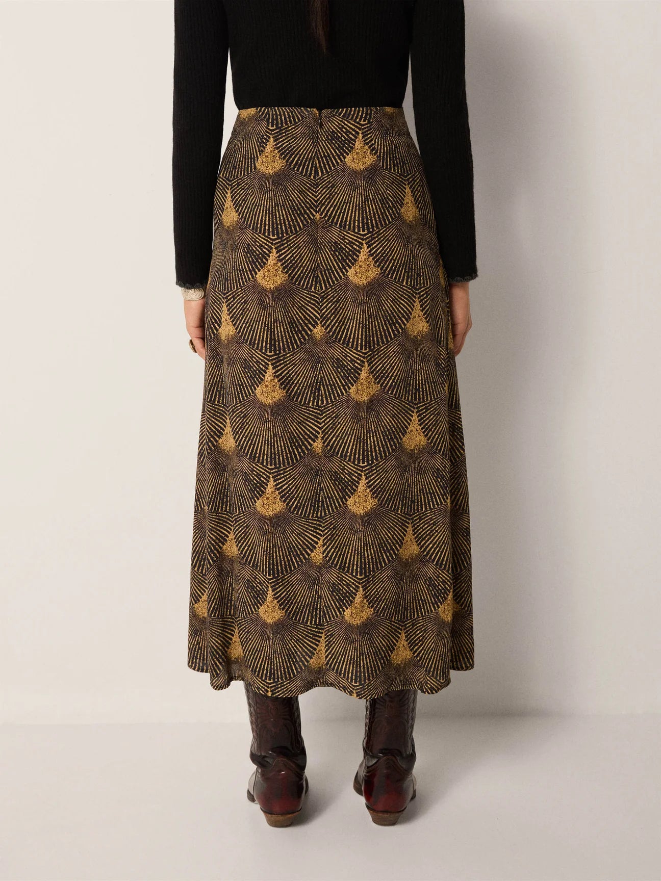 Person wearing a patterned skirt from Maison Hotel 