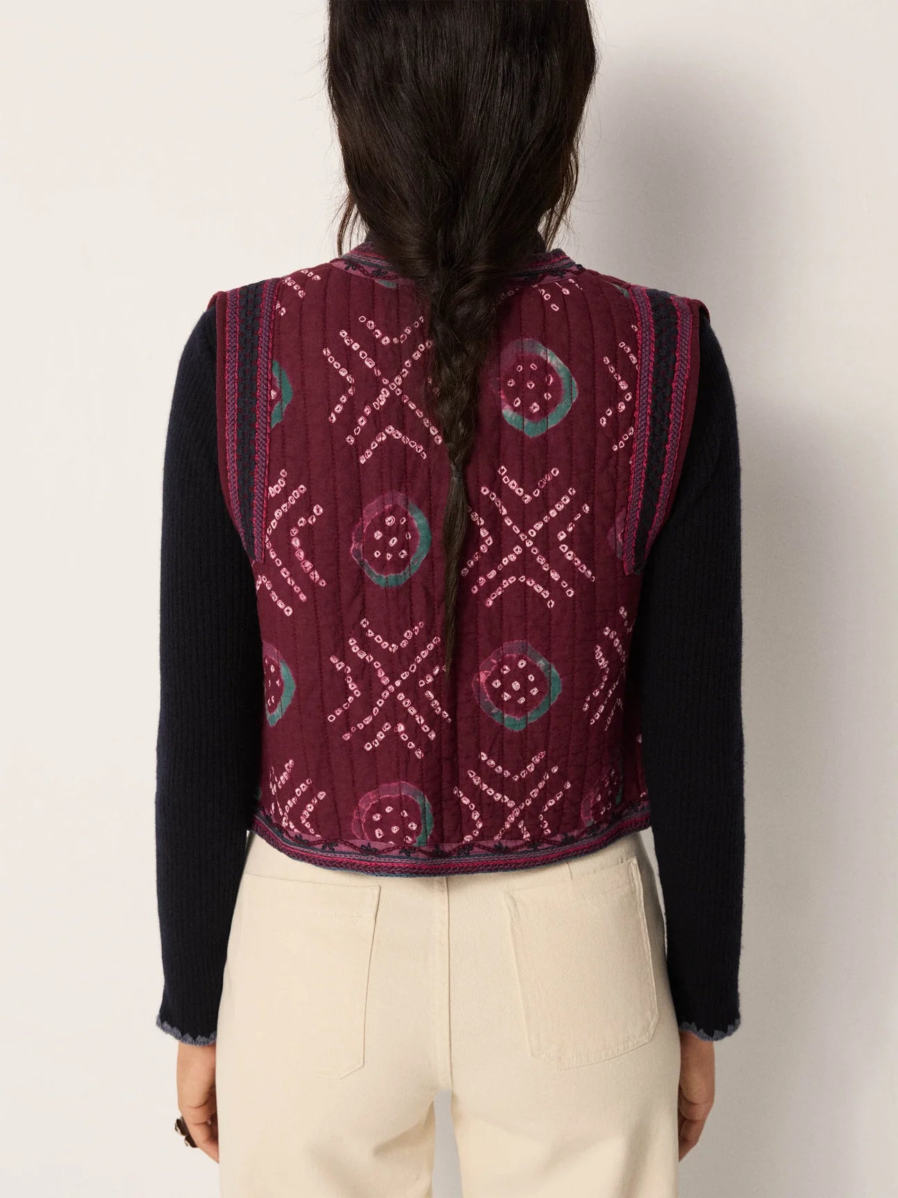 A woman wearing a quilted cotton gauze vest from Maison Hotel with hand-dyed geometric motifs