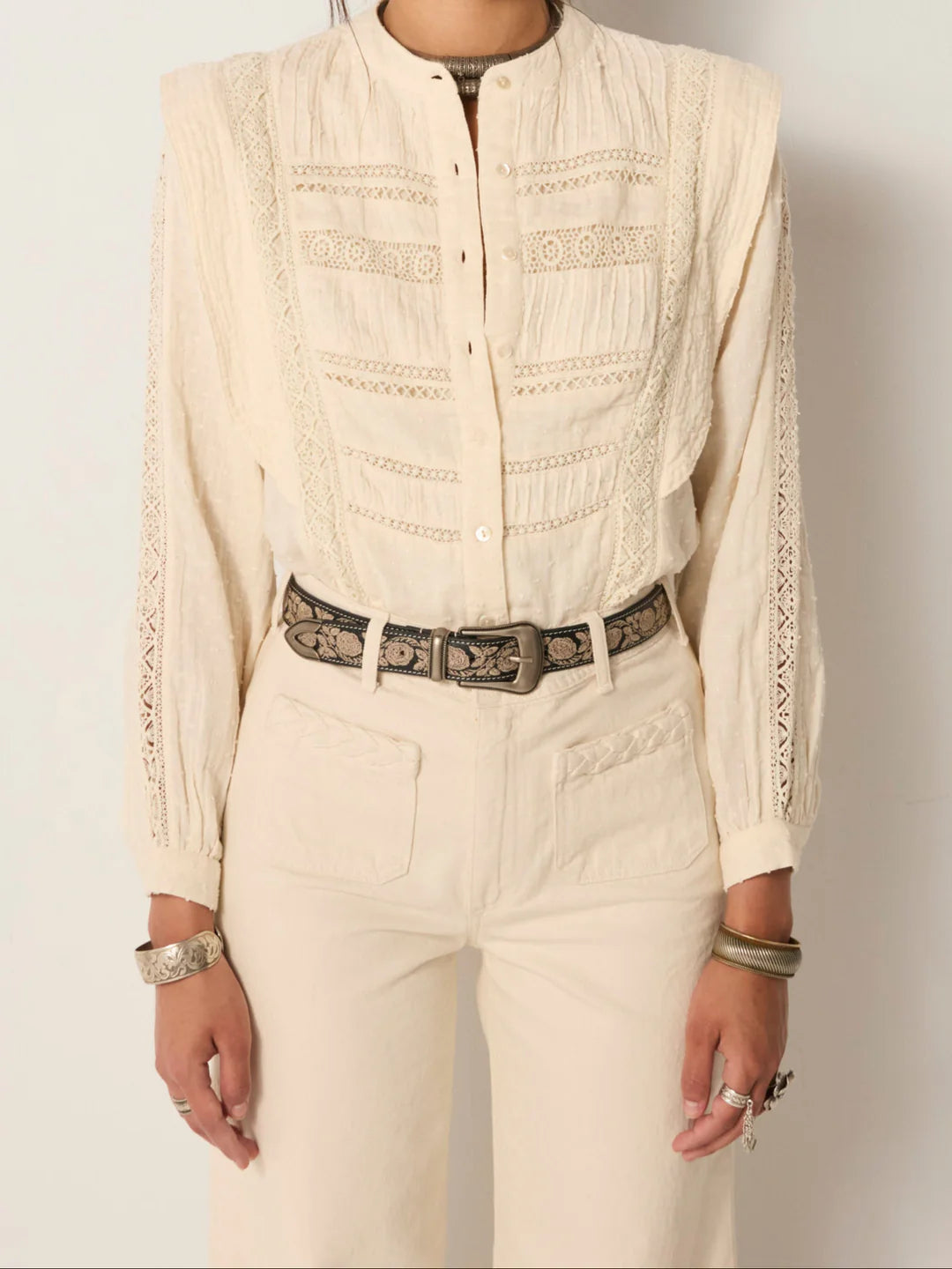 A woman wearing the Mariachi Onix Guadalupe leather belt by Maison Hotel