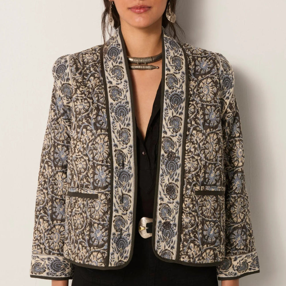 
                      
                        A woman wearing the Maison Hotel Sugata Jacket in Blue Orchid
                      
                    