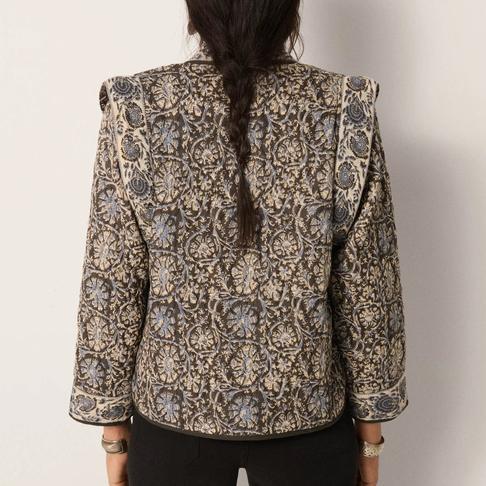 Woman wearing a patterned jacket with soft structure from Maison Hotel