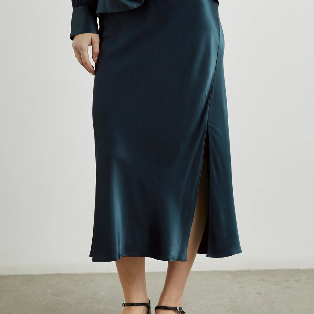 
                      
                        Front view of a woman wearing the Maya Midi Slip Skirt from Rails in the color Deep Sea
                      
                    