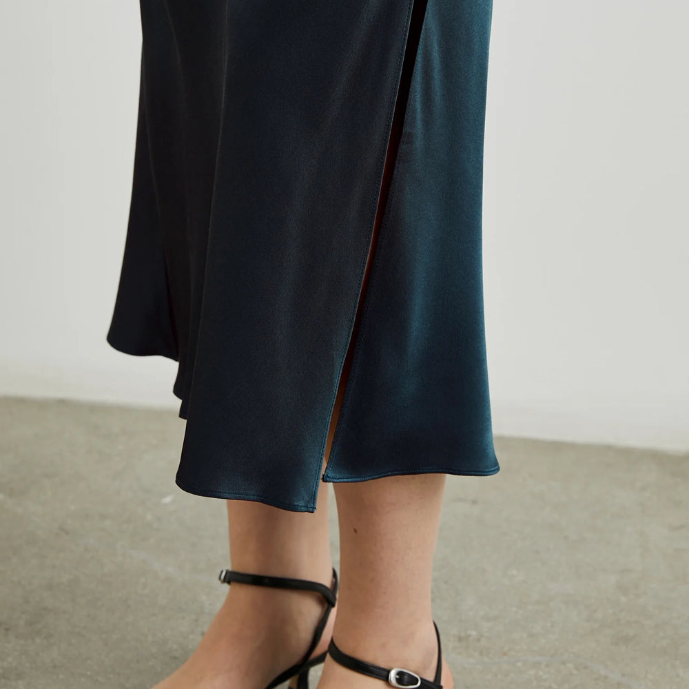 
                      
                        Skirt slit detail on the Maya Midi Slip Skirt from Rails in the color Deep Sea
                      
                    