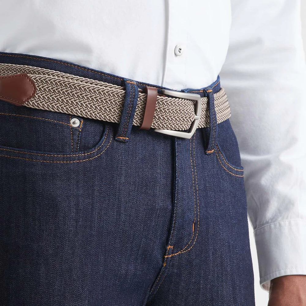 
                      
                        The Performance Stretch Belt in beige and brown by DU/ER
                      
                    