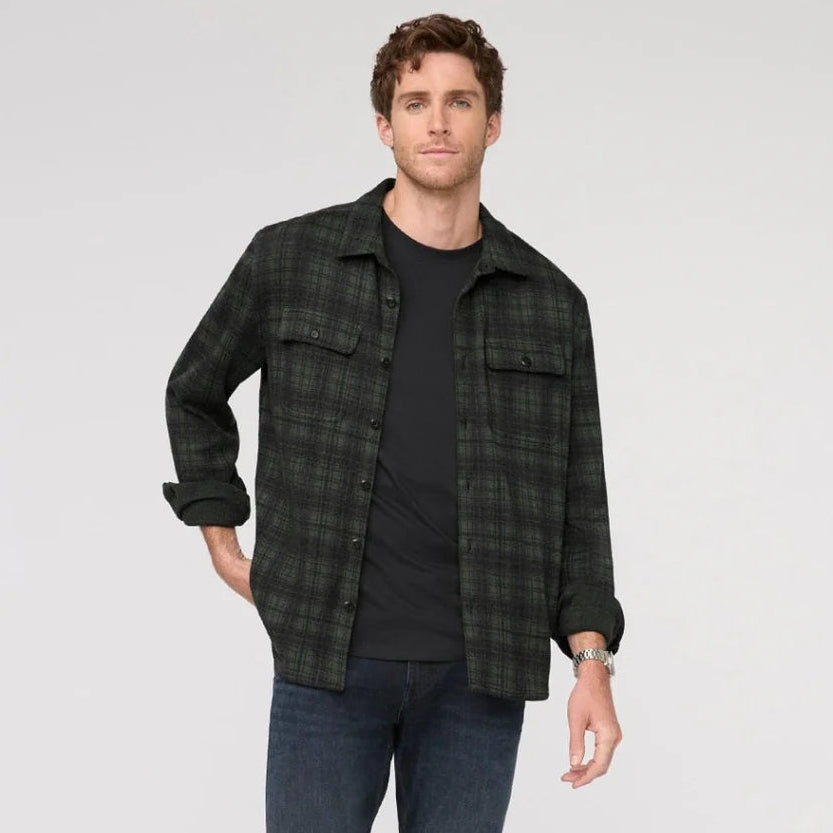 A man wearing the Performance Flannel Button Down in the color Heather Peat Plaid