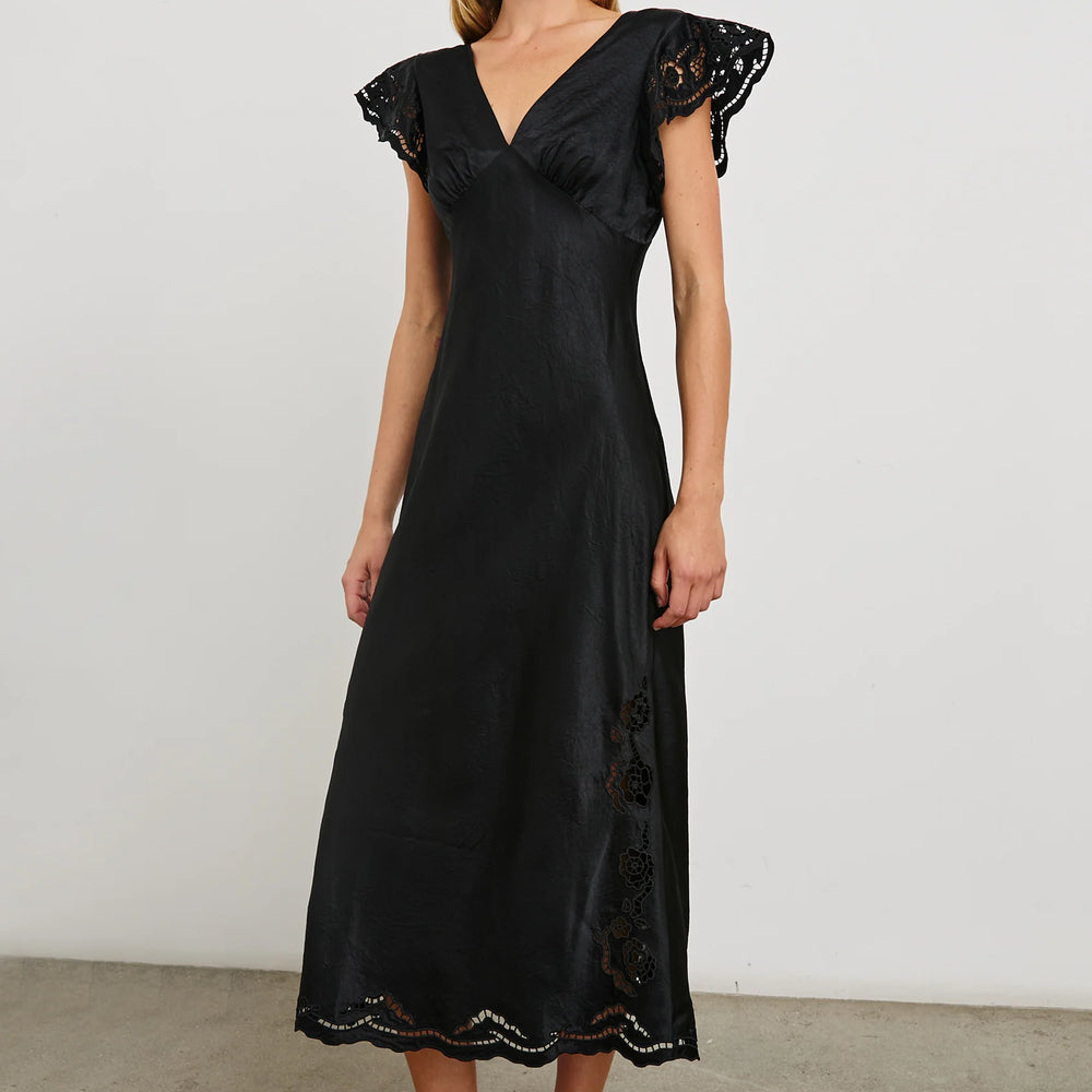 A woman wearing the Black Eyelet McKenna Satin Midi Dress by the brand Rails