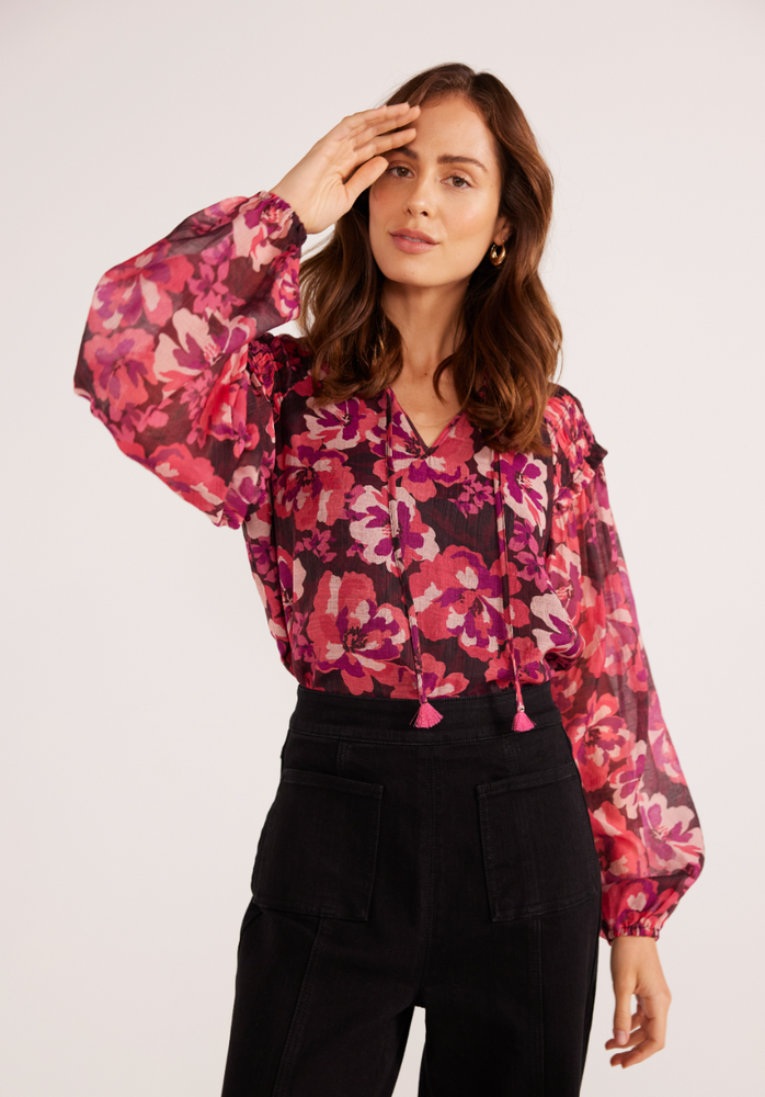 Front view of a woman wearing the floral print Savannah Long Sleeve Blouse by MINKPINK