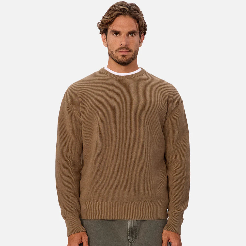 A man wearing the Industrie New England Crew Neck Sweater in the color Acorn